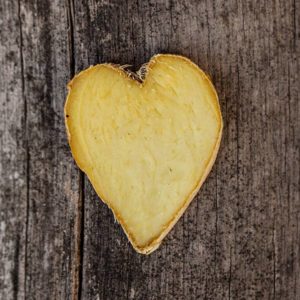 heart-shaped piece of ginger on wood